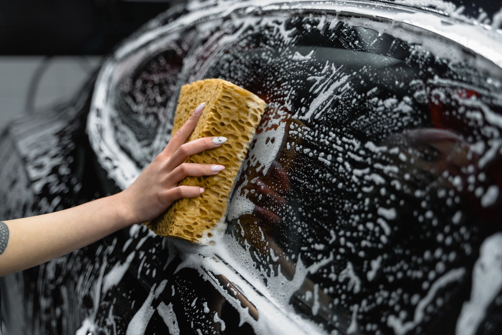 A member's car being hand washed in the bay