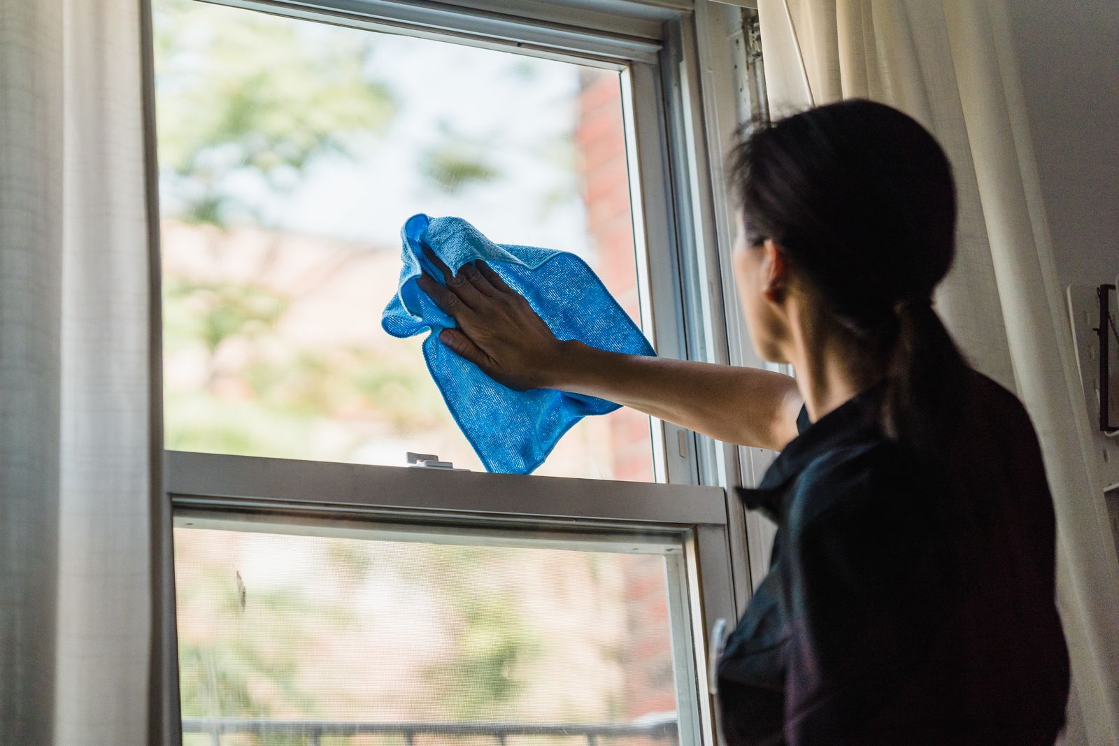 A car being hand dried with a microfiber towel
